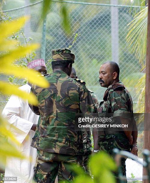 Major Fernando Pereira nicknamed Cobo talks with Arlesio Costa, chief of the Buffalos and Sao Tome's Nigerian ambassador 23 July 2003 at the Marlin...