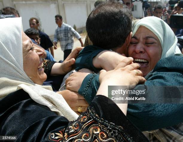 Released Palestinian prisoner is greeted by female relatives as he arrives at the checkpoint of Erez between Gaza city and Israel, northern Gaza...