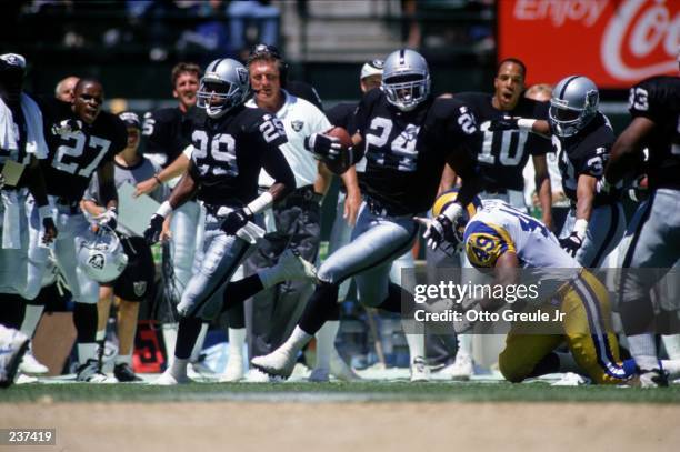 Defensive back Patrick Bates of the Los Angeles Raiders carries the ball after intercepting a pass during the Raiders 27-22 win over the Los Angeles...