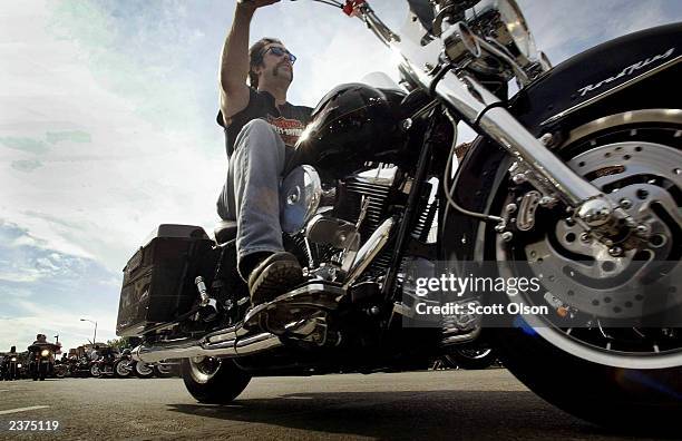 Biker rides down Main Street during the annual Sturgis Motorcycle Rally August 6, 2003 in Sturgis, South Dakota. The weeklong rally draws an...