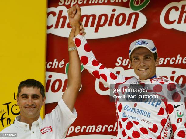 Frenchman Richard Virenque celebrates with former French cyclist Laurent Jalabert on the podium after he took the white and red polka-dotted jersey...