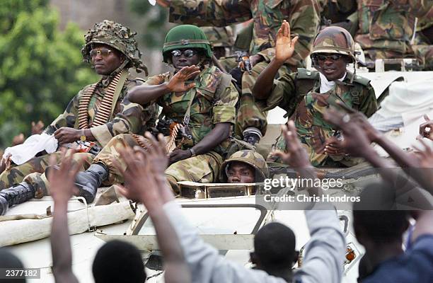 Liberians greet Nigerian peacekeepers making their first rounds through the center of the capital August 7, 2003 in Monrovia, Liberia. Jubilant...