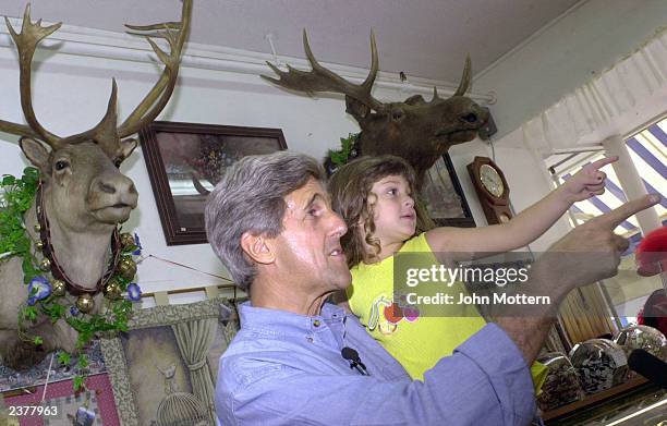 Democratic Presidential hopeful Senator John Kerry holds Alicia Arce at Chutter General Store during a walk around campaign tour on Main Street...