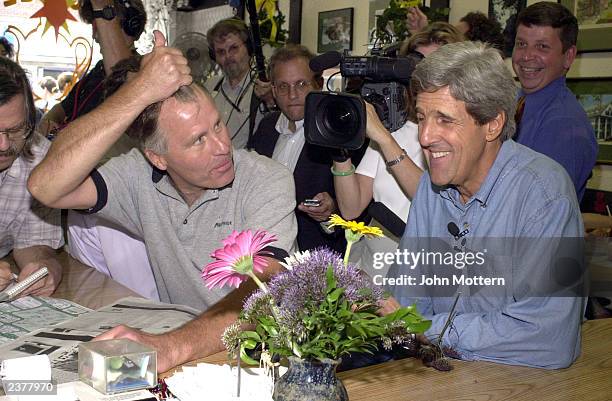 Democratic Presidential hopeful Senator John Kerry is asked about his hair by Ben Gumm at the Coffee Pot Cafe during a walk around campaign tour on...