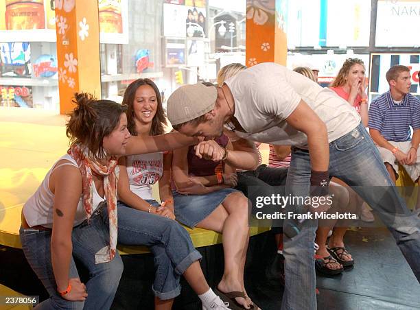 Actor Colin Farrell, one of the stars of the new film "S.W.A.T." kisses the hand of a fan on MTV TRL at the MTV Times Square Studios August 7, 2003...