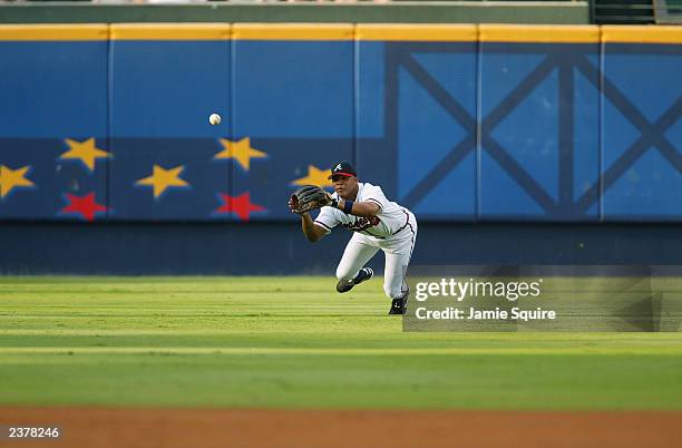 Centerfielder Andruw Jones of the Atlanta Braves dives for a ball during the MLB game against the Milwaukee Brewers at Turner Field on July 31, 2002...