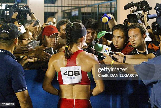 Mexican Ana Guevara speaks to journalists after winning the 400m semifinal 07 August 2003 at the Olympic Stadium during the XIV Pan American Games in...