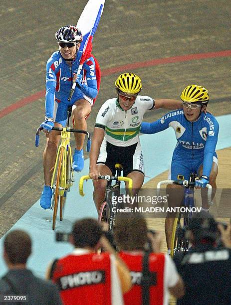 Russian Olga Slusareva waves her national flag after she won the final of the women's scratch on the fourth day of the UCI world track cycling...