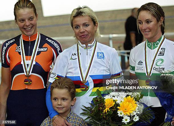 Dutch Adrie Visser, Russian Olga Slusareva with her son and Australian Rochelle Gilmore celebrate on the podium at the end of the final of the...