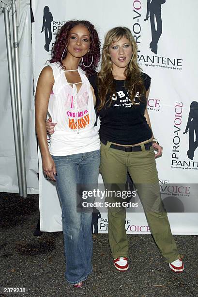 Singers Mya and Lucy Woodward pose backstage at the third annual Pantene Pro-Voice Concert on August 7, 2003 in New York City. The concert is...