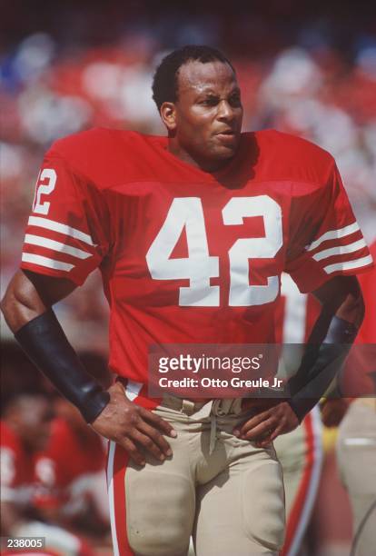 Strong safety Ronnie Lott of the San Francisco 49ers stands and relaxes on the sideline while the offense is on the field during the 49ers 19-13...