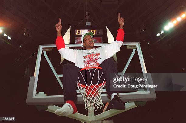 INJURED ARKANSAS GUARD ROGER CRAWFORD CELEBRATES ATOP THE RIM AFTER THE RAZORBACKS DEFEATED DUKE, 76-72, IN CHARLOTTE, NORTH CAROLINA. THE TEAM HAD...