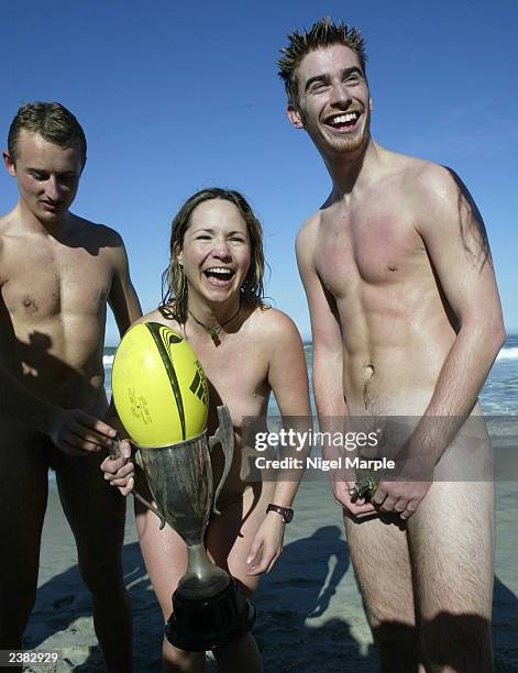 The International Barbarians Simon Brown, Andrea Cooper, and Nick Treadwell celebrate with a trophy after beating the Kiwi Selection 7-0 during the...