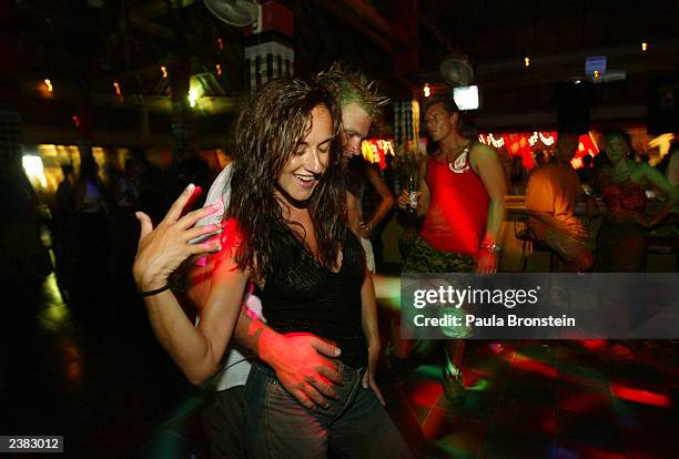Foreign tourists dance in a newly reopened Paddy's Club August 9, 2003 in Kuta, Bali. Paddys Club is one of the two night clubs that a series of...