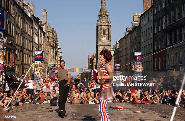 Street Artists perform during the Fringe festival before the start of the Edinburgh International Festival at the Royal Mile, in the centre of...