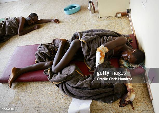 Liberians who had been bound and suffer from gangrenous limbs are left to die in a separate room at a beer factory used as a medical clinic August...