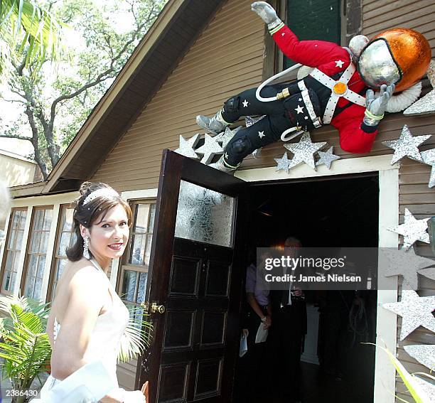 Ekaterina Dmitriev, the bride of Russian cosmonaut Yuri Malenchenko, enters a reception at the Villa Capri restaurant in Seabrook, Texas after she...