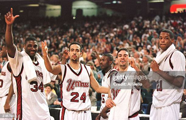 Tyrone Weeks, Carmelo Travieso, Edgar Padilla and Marcus Camby of the UMass Minutemen poses for a portrait while celebrating in the final seconds of...