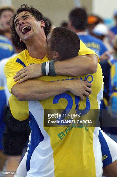 Brazilian handball players Alexandre Folhas and Gustavo Silva celebrate after defeating Argentina 31-30 winning the the gold medal at the XIV Pan...