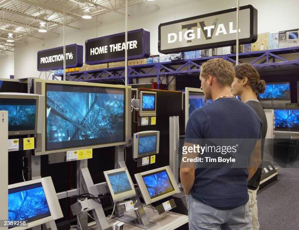 Two shoppers peruse LCD and Plasma televisions at a Best Buy store August 11, 2003 in Niles, Illinois. Best Buy Co., Inc. Raised its estimate for...