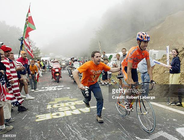Alberto Lopez de Munain of Spain, riding for the Euskatel-Euskadi Team, gets a push from a supporter while climbing the Col Bagarguy during stage...
