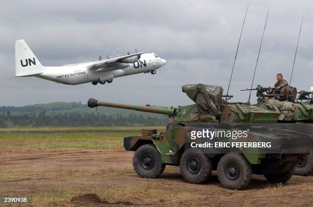 Hercule C 130 takes off while French soldiers watch over the situation with light tanks Sagaie, 10 june 2003 at Bunia airport. An emergency mission...