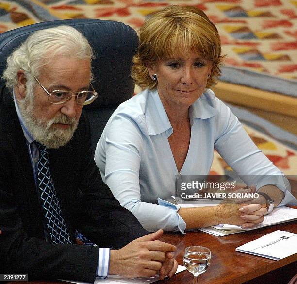 Spanish Popular Party deputies Eduardo Cortes and Esperanza Aguirre look at elected on the lists of the Spanish Socialist Party , Eduardo Tamayo and...