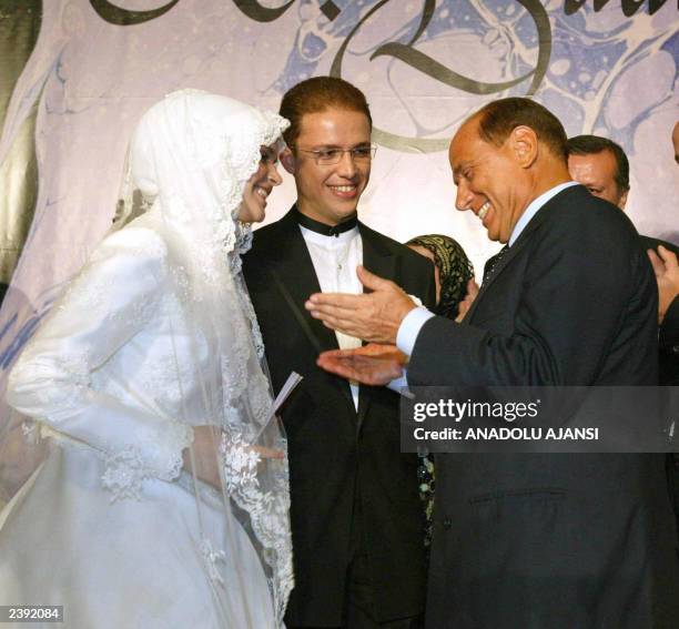 Turkish Prime Minister Recep Tayyip Erdogan's son Bilal Erdogan and his teenage bride Reyyan Uzuner chatting with Italian Prime Minister Silvio...