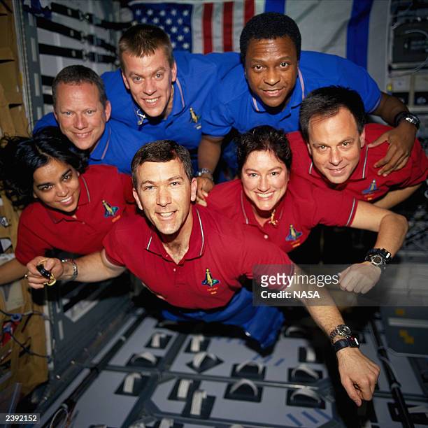 In this handout photo from the National Aeronautics and Space Administration , the STS-107 crewmembers strike a flying pose for their traditional...