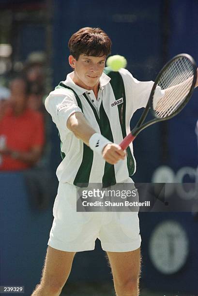 Tim Henman of Great Britain focuses on the ball just before attempting a back hand return during his match against Doug Flach of the USA in the...