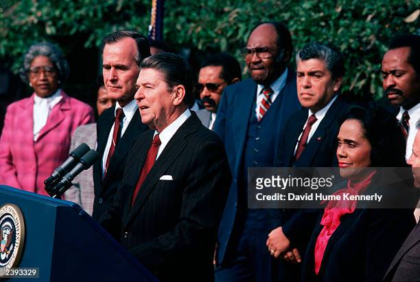 President Ronald Reagan makes a speech as Vice President George H.W. Bush and Coretta Scott King, widow of Dr. Martin Luther King Jr., listen...