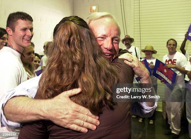 Sen. Joe Lieberman gets a hug from Jenny Weiss at a pre-forum barbecue August 12, 2003 in Stillwater, Oklahoma. Seven of the nine declared Democrats...