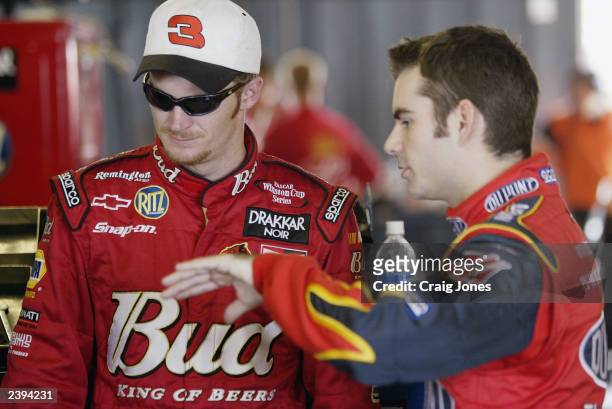 Dale Earnhardt Jr, driver of the Budweiser Chevrolet, talks with Jeff Gordon, driver of the Hendrick Motorsports Dupont Chevrolet, during practice...