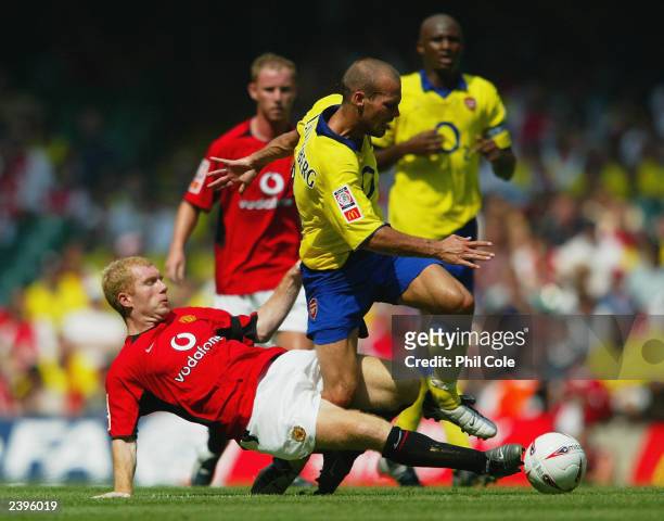 Freddie Ljungberg of Arsenal is tackled by Paul Scholes of Manchester United during the FA Community Shield match between Arsenal and Manchester...