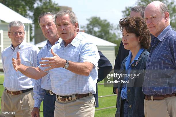 President George W. Bush gestures as he speaks with the media while OMB Director Joshua Bolten , U.S. Commerce Secretary Don Evans , U.S. Labor...