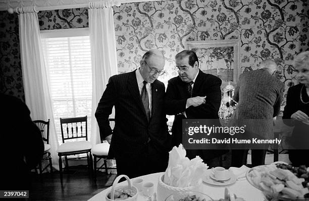 Chairman of the Federal Reserve Board Alan Greenspan and U.S. Supreme Court Justice Antonin Scalia talk during a gathering for John E. Robson,...
