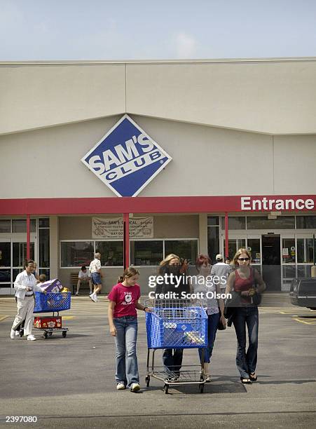 Shoppers leave a Sam's Club store August 13, 2003 in Des Plaines, Illinois. Wal-Mart Stores Inc., the parent company of Sam's Club, reported strong...