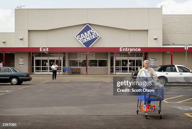 Shoppers leave a Sam's Club store August 13, 2003 in Des Plaines, Illinois. Wal-Mart Stores Inc., the parent company of Sam's Club, reported strong...