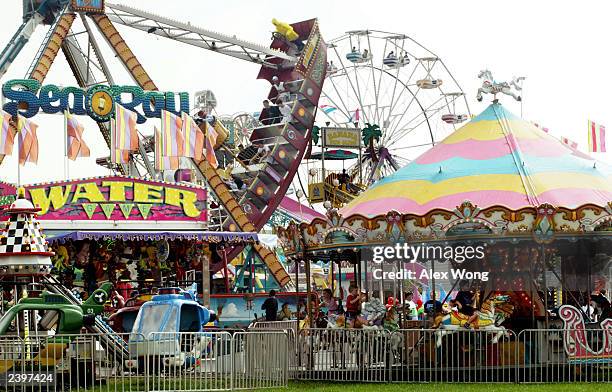 Local residents enjoy carnival rides during their visit to the Montgomery County Agricultural Fair August 13, 2003 in Gaithersburg, Maryland. The...