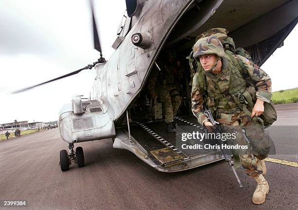 Marines of the 26th Marine Expeditionary Unit arrive at Roberts International August 14, 2003 on the outskirts of Monrovia, Liberia. Marines were...