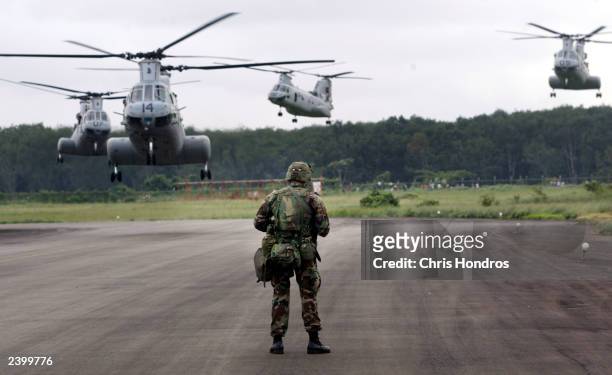 Marine of the 26th Marine Expeditionary Unit watches four transport helicopters depart Roberts International August 14, 2003 on the outskirts of...