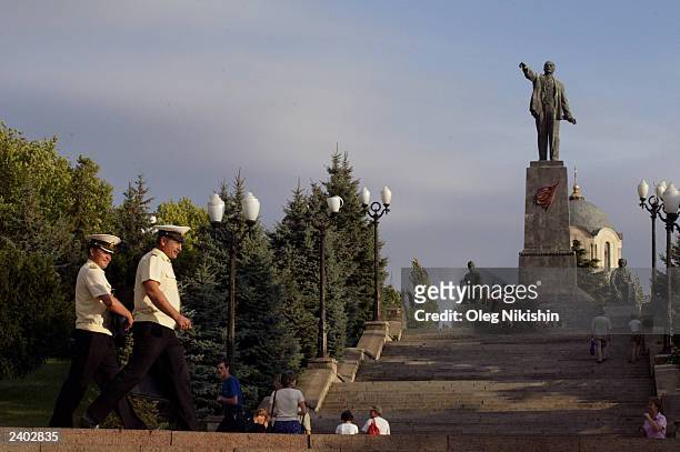Russian naval officers walk past a monument to Vladimir Lenin, founder of the communist Soviet Union state, August 15, 2003 in Sevastopol, Crimea in...