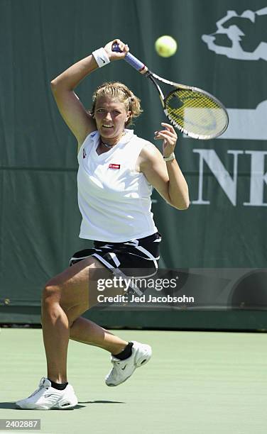 Marie-Gaianeh Mikaelian of Switzerland returns a shot against Kim Clijsters of Belgium during the quaterfinals of the Bank of the West Classic at...