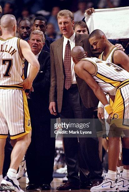 Head coach Larry Bird of the Indiana Pacers talks to his team during a game against the Golden State Warriors at the Market Square Arena in...