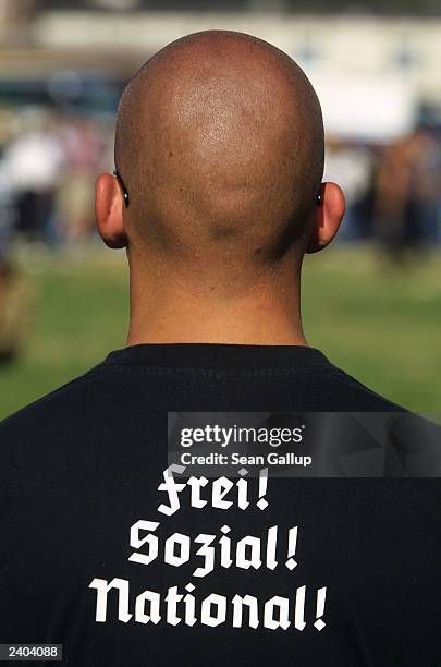Skinhead wearing a t-shirt that reads "Free! Social! National!" in reference to the National Socialism of the Nazis attends a march August 16, 2003...