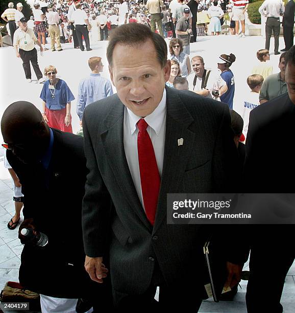 Alabama Chief Justice Roy Moore leaves a rally in support of a monument of the Ten Commandments August 16, 2003 in Montgomery, Alabama. Moore said...