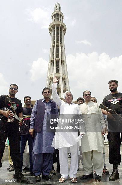 Former Chief Minister of the Indian state of Bihar, Laloo Prasad Yadav , waves at visitors in front of the Minar-e-Pakistan in Lahore, 13 August...