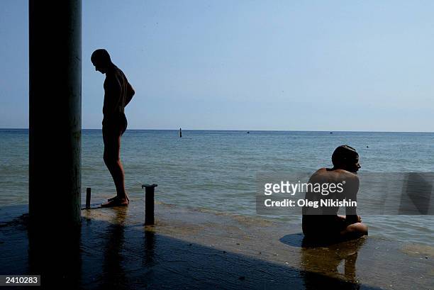 Sunbathers take to the water's edge on the beach of Yalta August 18, 2003 in Crimea, Ukraine. After the number of annual visitors to the Black Sea...