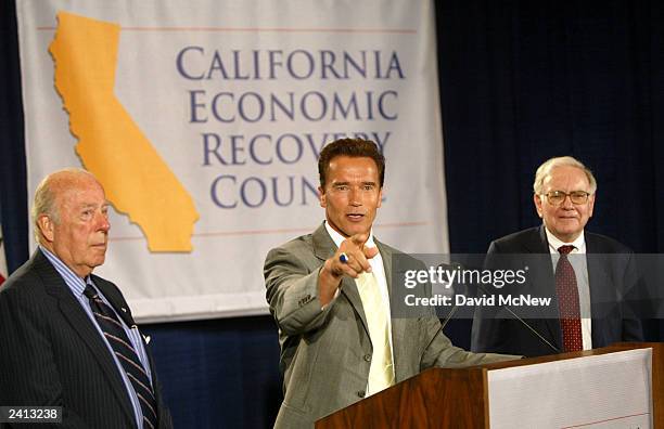 Actor Arnold Schwarzenegger calls on a reporter during a news conference after meeting with high-profile economic advisers, billionaire investor...