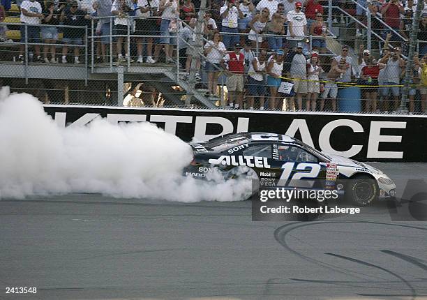 Ryan Newman driver of the Roger Penske Racing Alltel Dodge burns rubber after winning the NASCAR Winston Cup GFS Marketplace 400 on August 17, 2003...